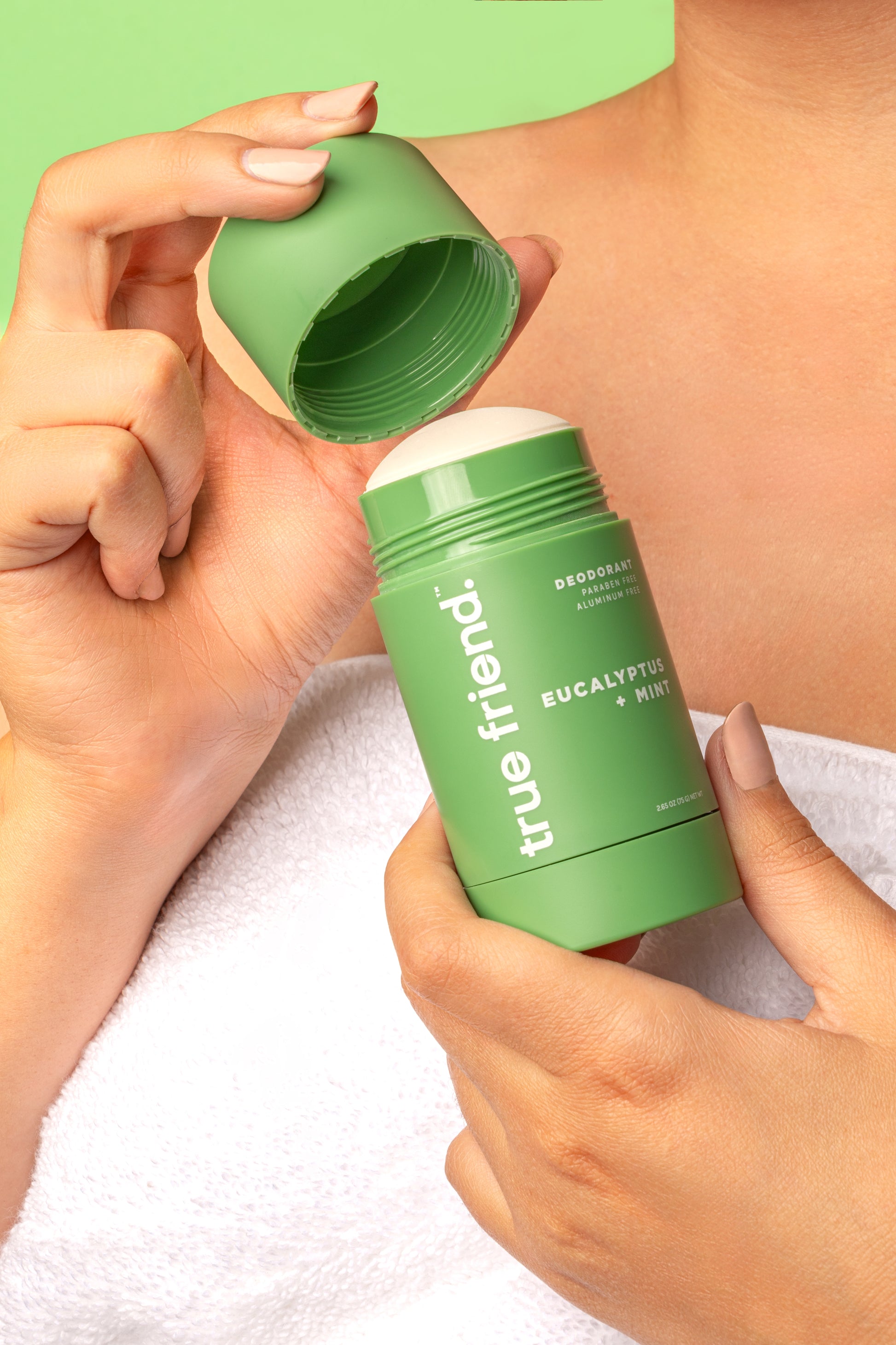 woman holding True Friend deodorant with cap off