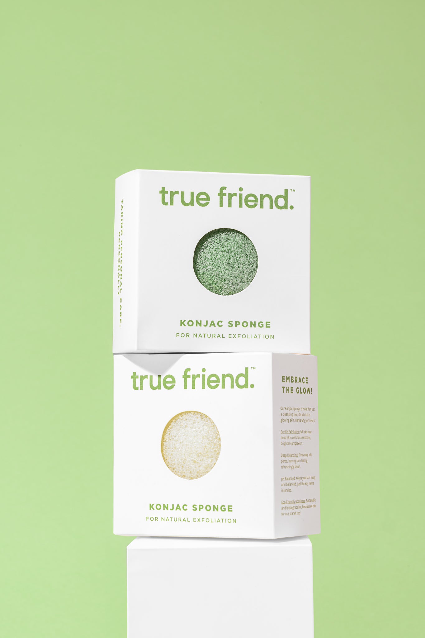 Two boxes of True Friend Konjac Sponge, on top of the other, against a light green background. The front of the sponge is visible, and the packaging has the brand name and product description.