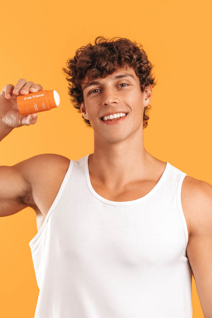 man holding True Friend vanilla + citrus deodorant